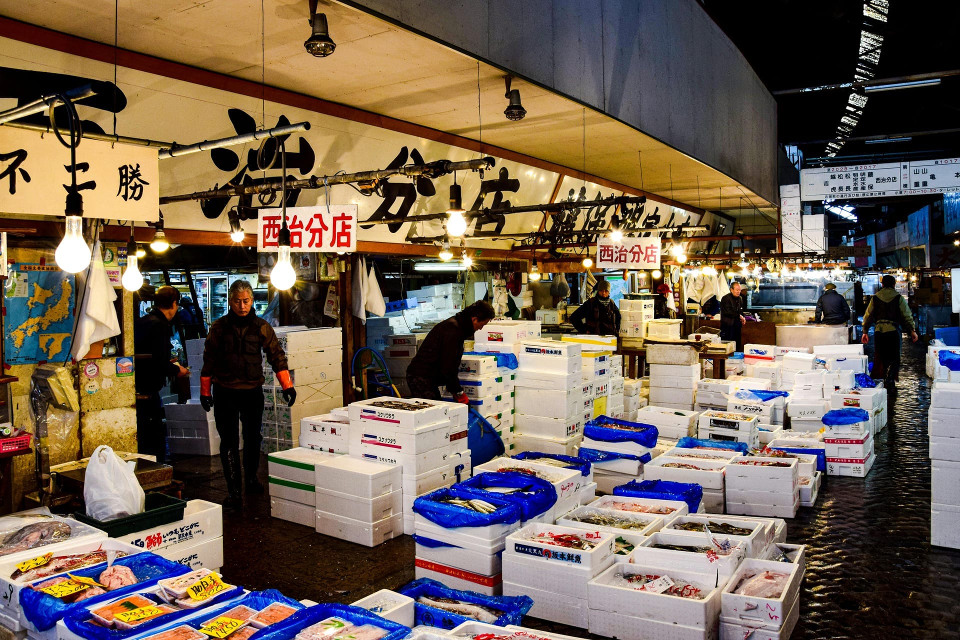 Tamagoyaki shops and grilled seafood stalls lining the crowded Tsukiji Outer Market alleyways in the morning, Tokyo, Japan